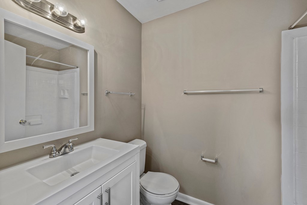 a bathroom with a sink toilet and mirror