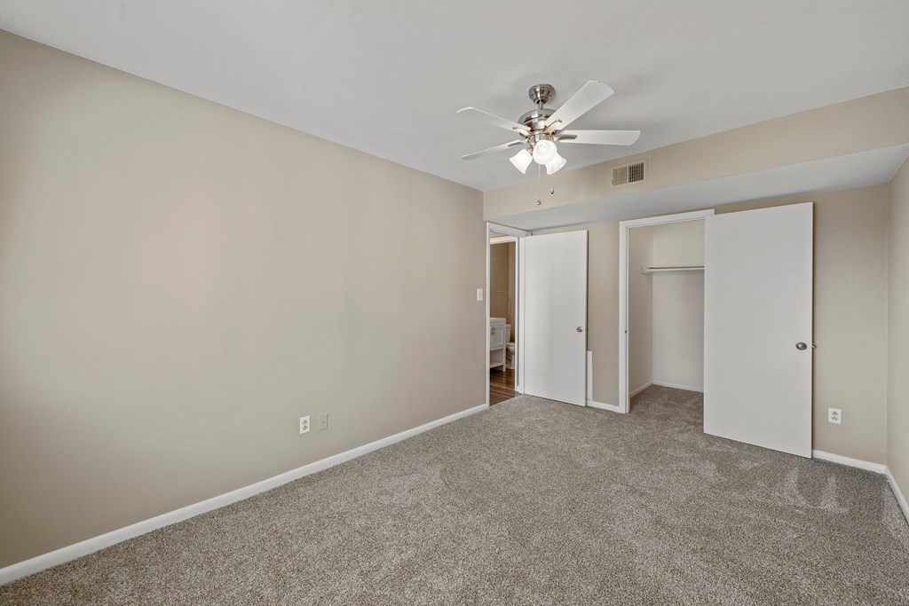 a bedroom with a ceiling fan