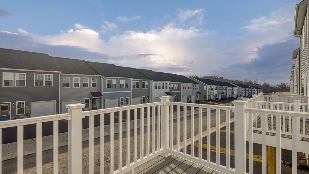 Building with balconies and a sidewalk at The Mark Townhomes Apartments, Harrisonburg, VA