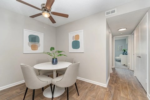a dining room with a table and chairs and a ceiling fan at Village 1373, Greensboro, NC 27455