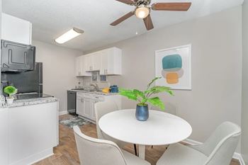 a kitchen and dining room with a table and chairs at Village 1373, North Carolina, 27455
