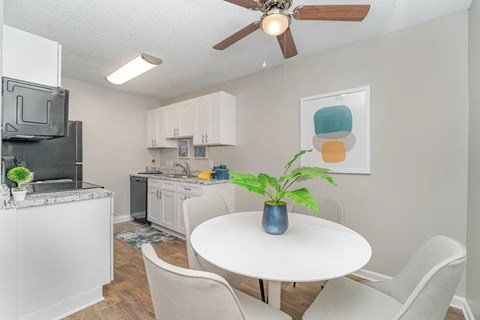 a kitchen and dining room with a table and chairs