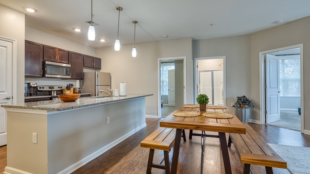 an open kitchen and dining room with a wooden table