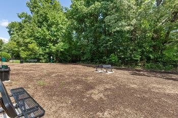 a picnic area with a grill and benches in a park at Village 1373, Greensboro, NC