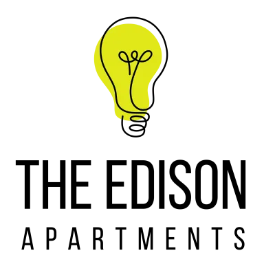 A yellow light bulb with a drawing of a pair of scissors on it.