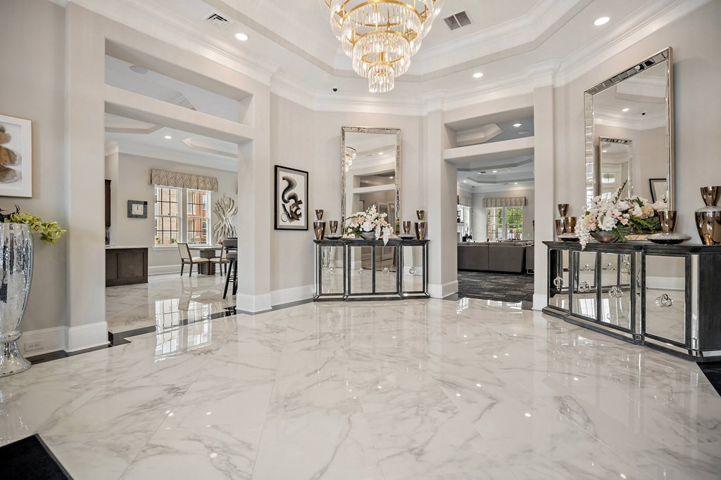 the lobby of the home has marble flooring and a chandelier at Ellis Station, Durham, 27703