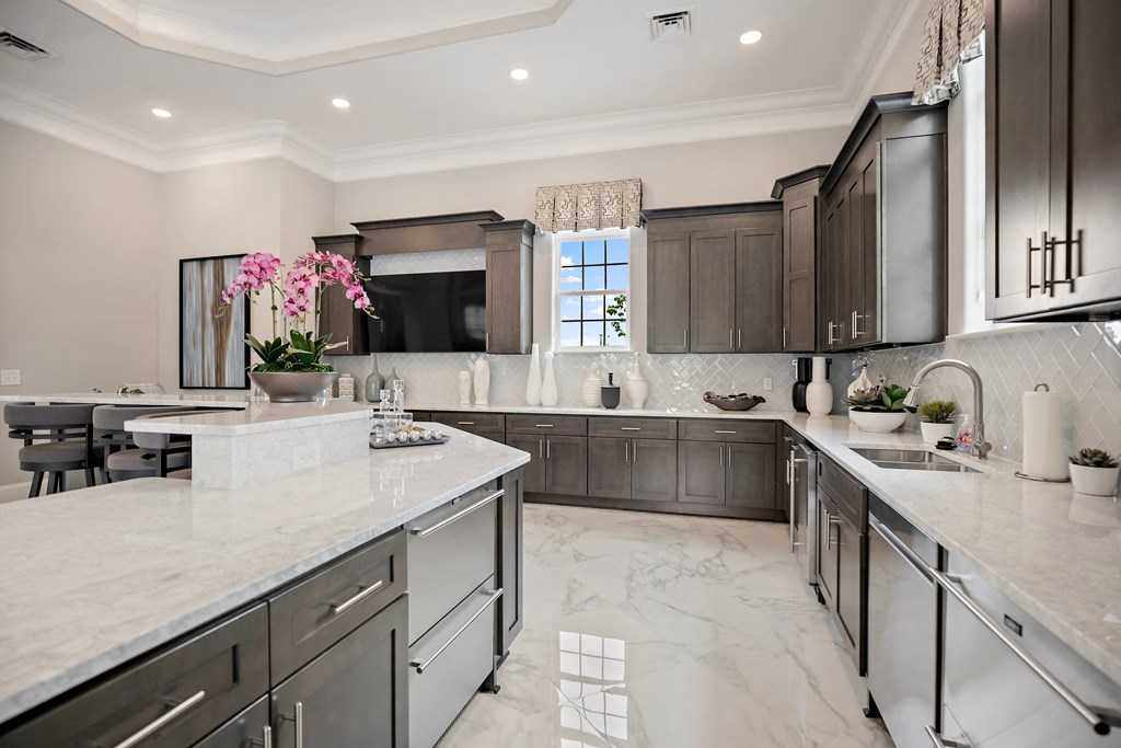 a large kitchen with marble counter tops and dark cabinets at Ellis Station, Durham, NC