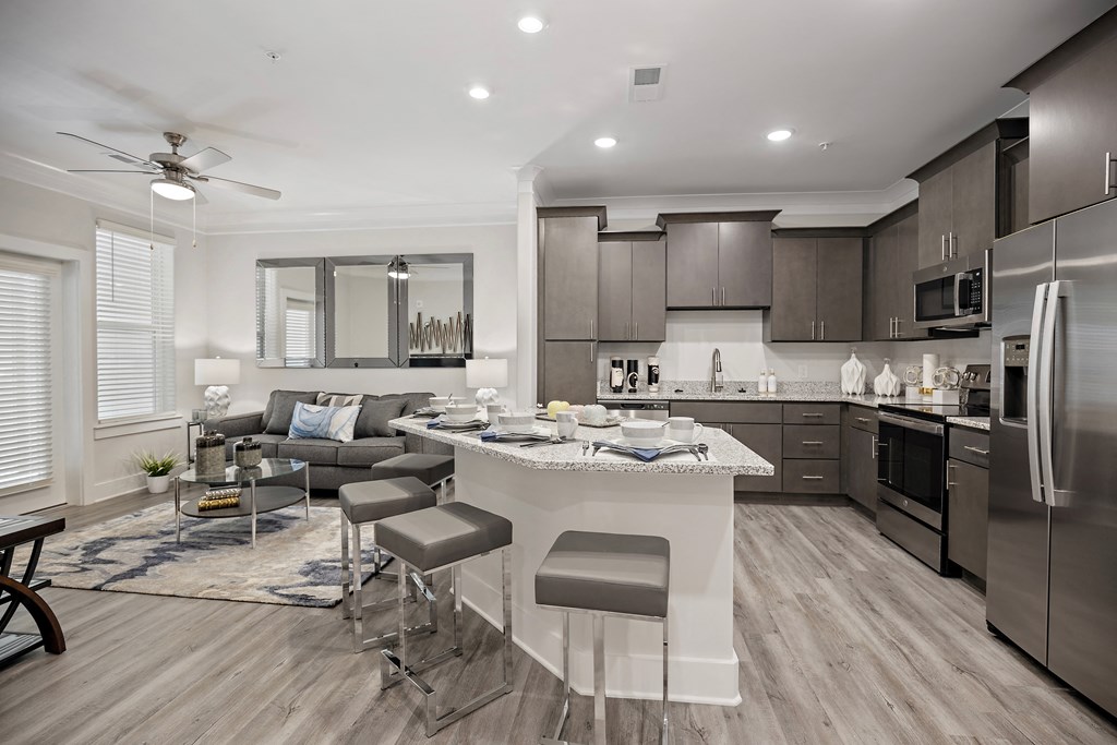 a white and black kitchen and living room with a table and chairs at Ellis Station, Durham, NC, 27703