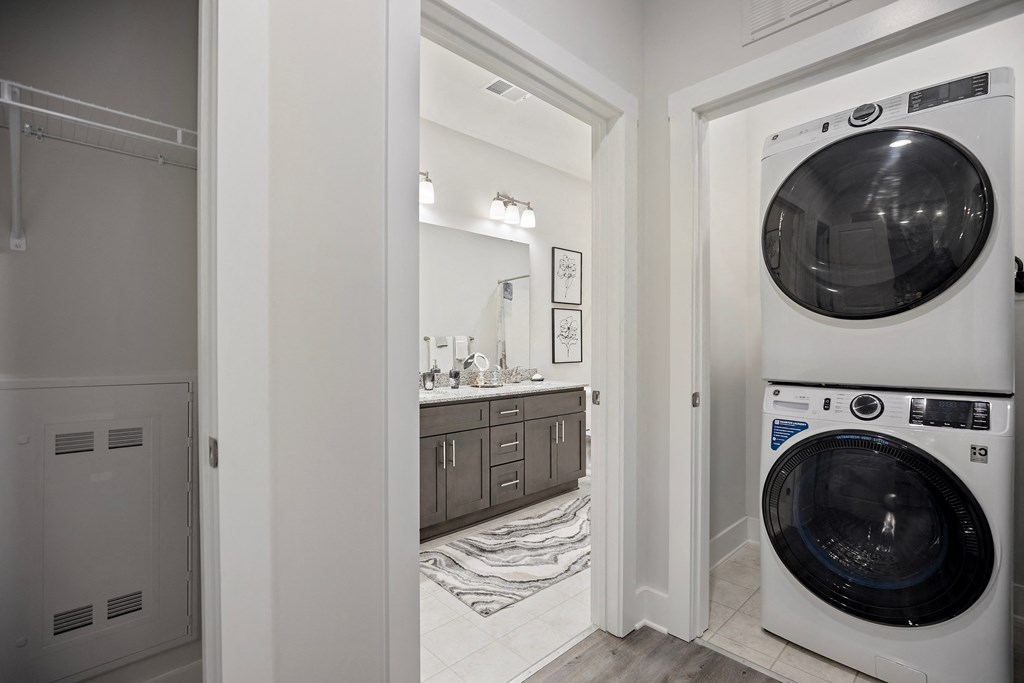 a washer and dryer in a laundry room next to a bathroom at Ellis Station, Durham