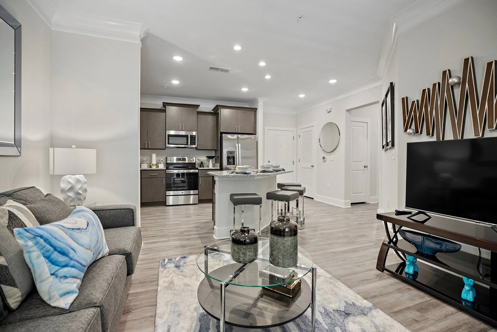 a living room with a couch and a glass table at Ellis Station, Durham, 27703