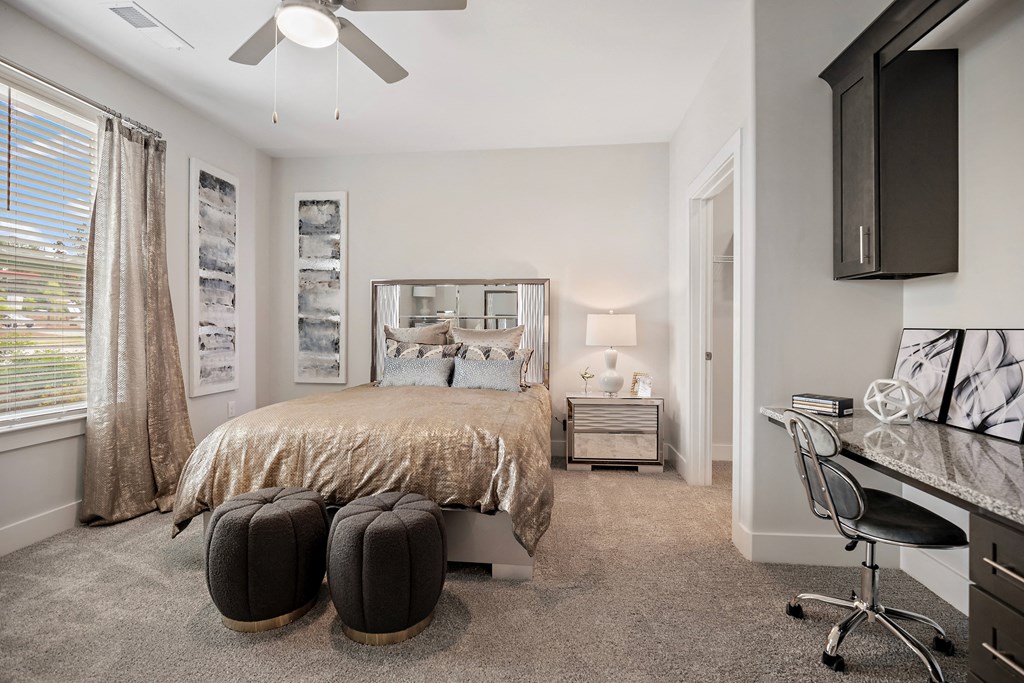a bedroom with a bed and a desk with a chair at Ellis Station, Durham
