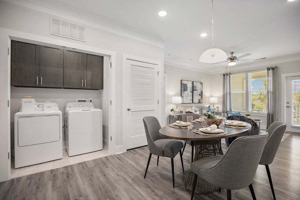 a kitchen and dining area with a washer and dryer and a dining table at Ellis Station, Durham