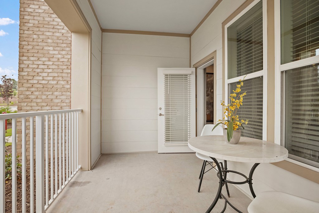 a balcony with a table and chairs and a door at Ellis Station, North Carolina