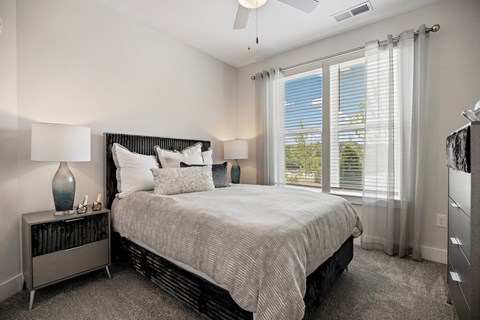 a bedroom with a bed and a large window at Ellis Station, North Carolina, 27703