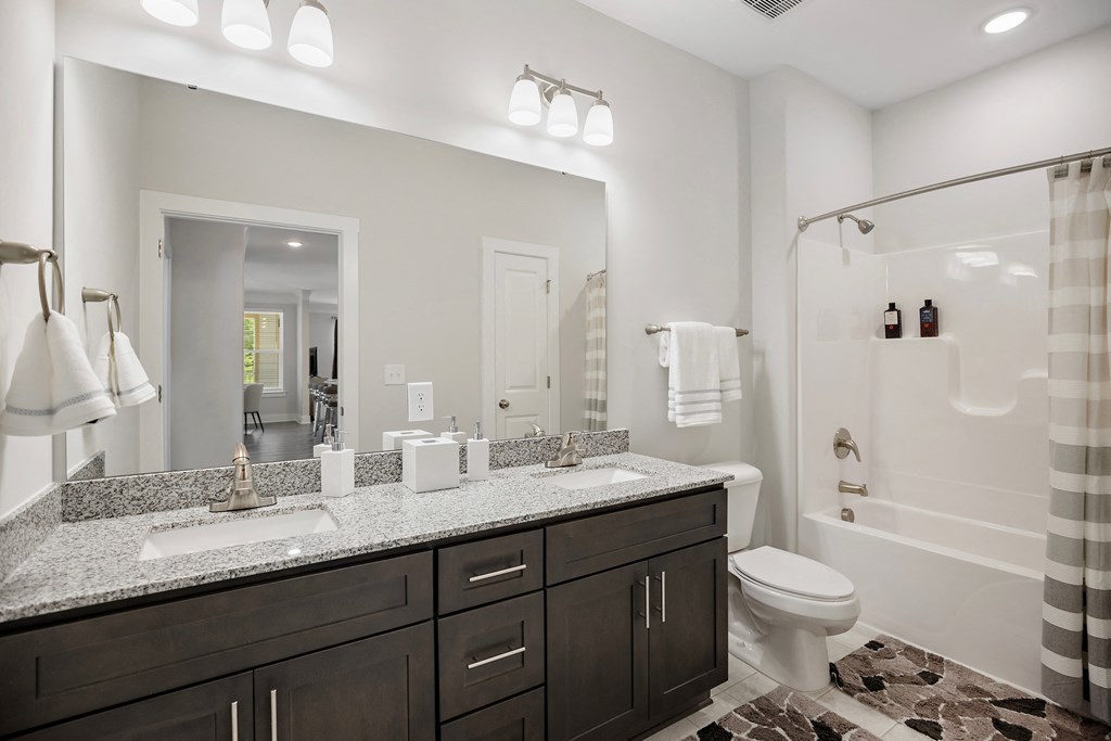 a bathroom with two sinks and a shower and a toilet at Ellis Station, Durham, North Carolina