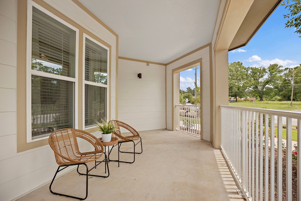 a patio with two chairs and a table on a balcony at Ellis Station, Durham, NC, 27703