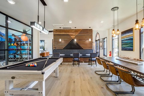 a game room with a pool table and a bar