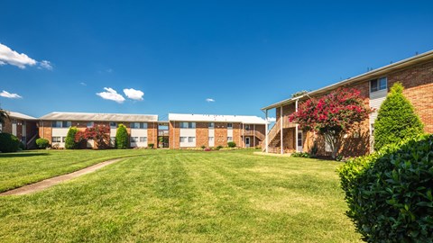 A building with a green lawn in front of it.
