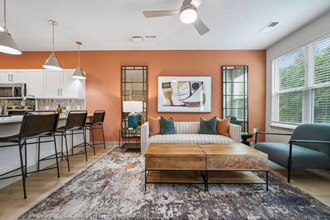 A bedroom with a bed, a couch, and a dining table.