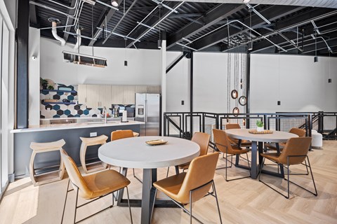 A modern dining area with a white table and chairs.
