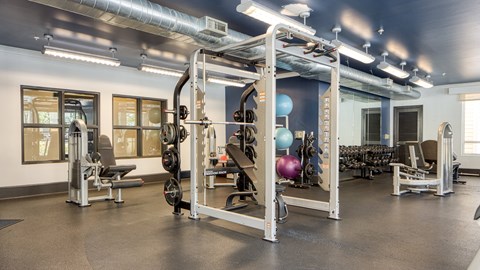 a gym with weights and other exercise equipment in a building