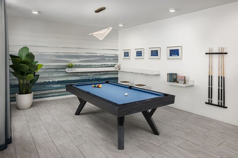 A pool table in a room with a painting on the wall at The Port at East Beach Apartments and Marina in Virginia, 23518