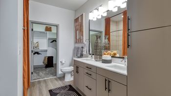 a bathroom with a large mirror and a sink and a toilet at Aura Stonebridge, Richmond, VA