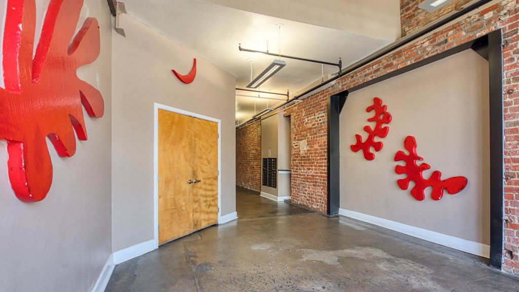 a hallway with a door and a mural symbols on the walls
