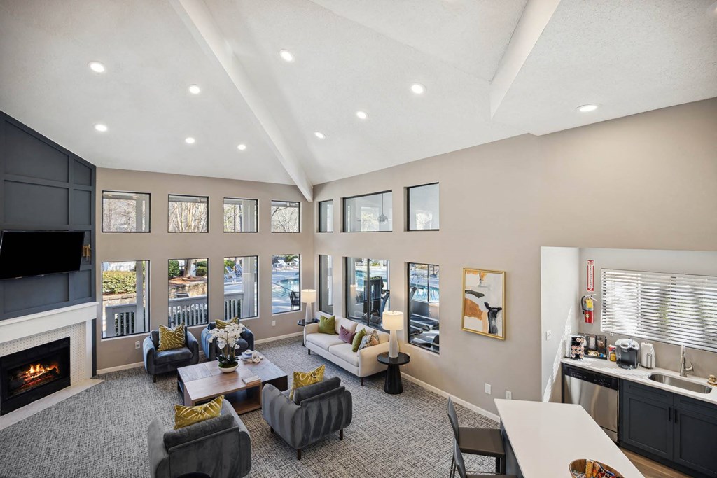 a living room with couches and chairs and a fireplace