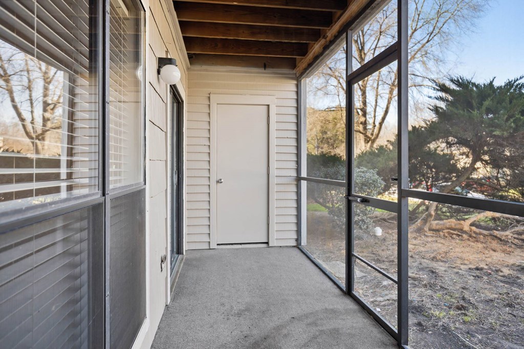 the front porch of a house with a white door