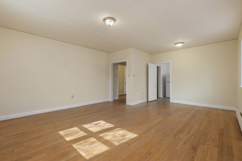 A room with wooden floors and white walls.