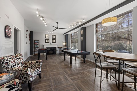 A room with a pool table and a couch.