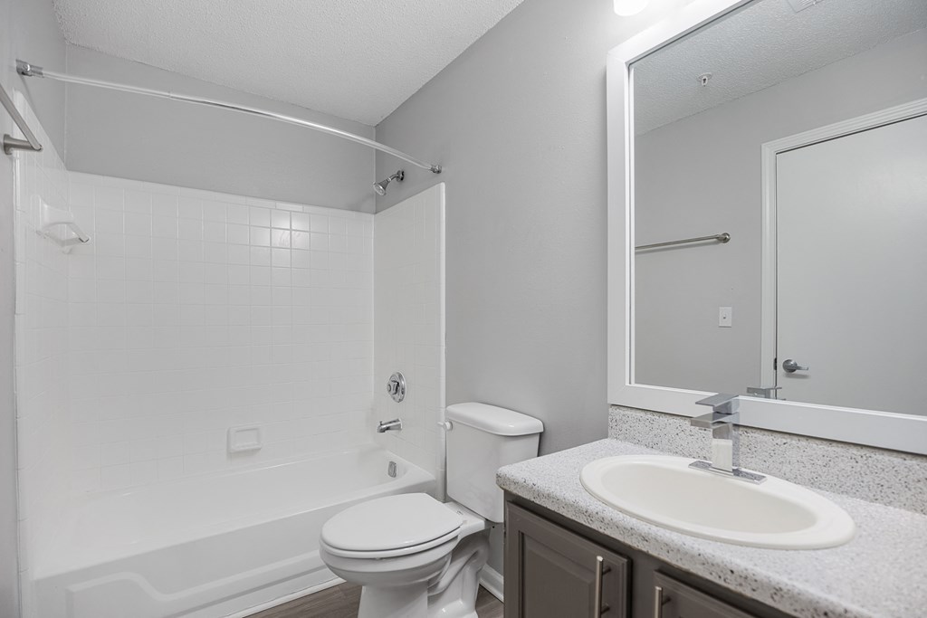 a bathroom with a shower toilet and sink and a mirror at Midtown Crossing in Raleigh, 27609