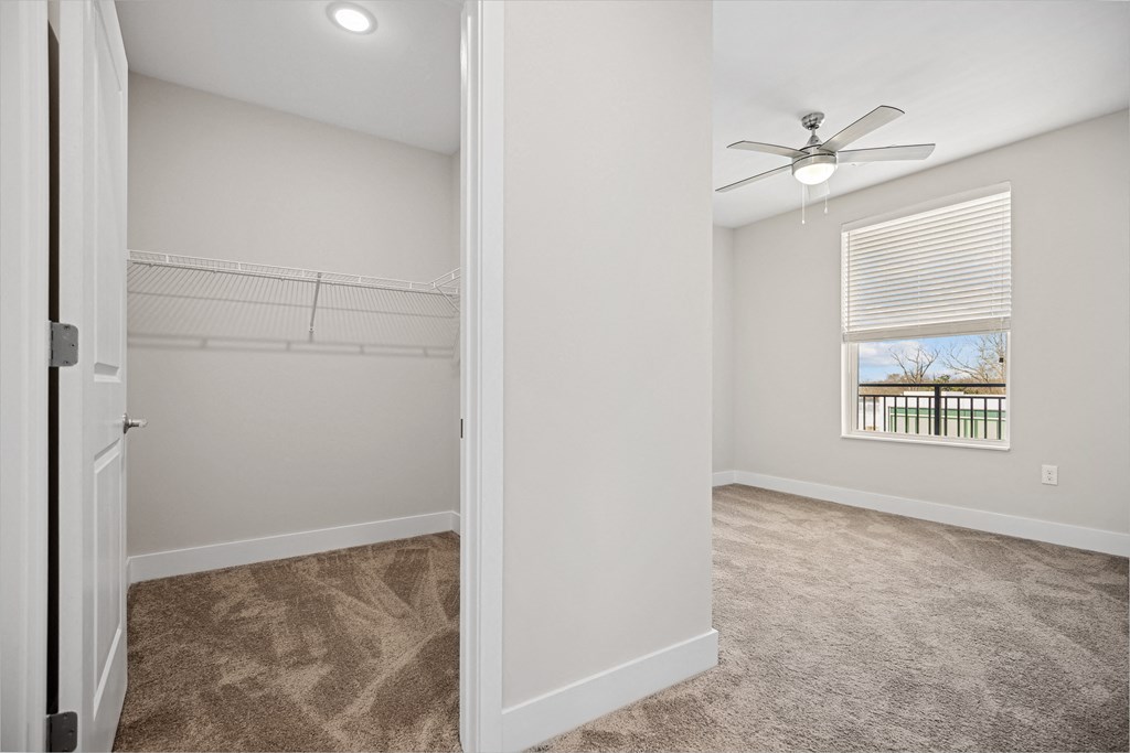 an empty bedroom with a ceiling fan and a windowat Centro at Pine Nash, Wilson, 27893
