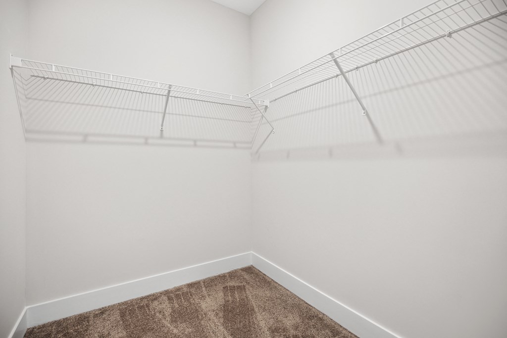 an empty closet in a room with white walls and carpetat Pine Nash, Wilson, NC, North Carolina, 27893