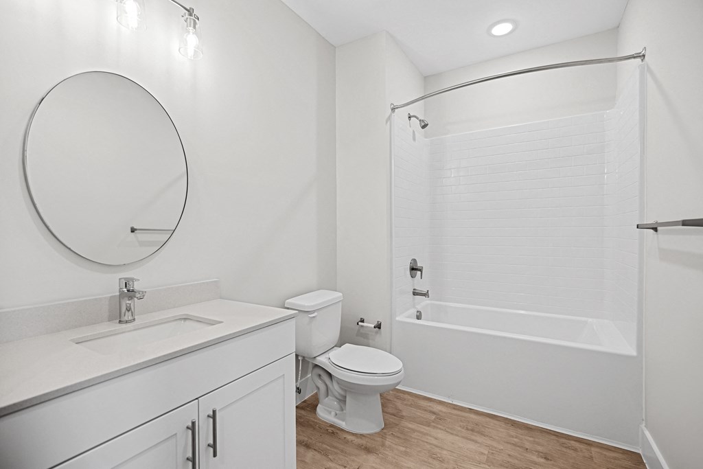 a bathroom with a toilet and a tub and a sinkat Centro at Pine Nash, Wilson, NC