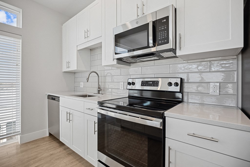 the preserve at ballantyne commons apartment kitchen with stove and microwaveat Centro at Pine Nash, Wilson, NC, 27893