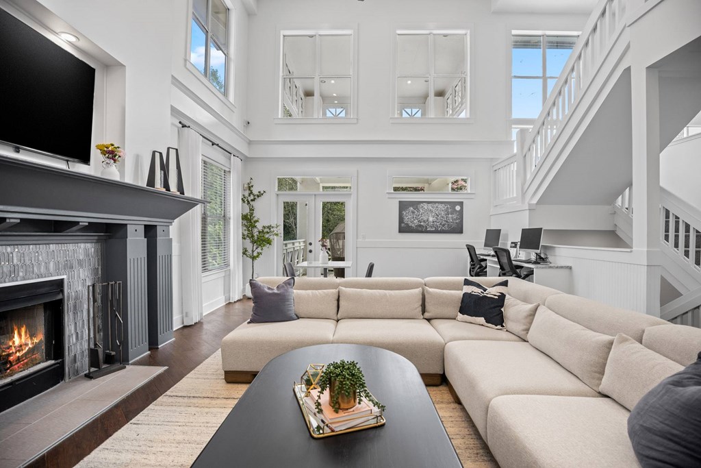 A modern living room with a fireplace and a large couch.