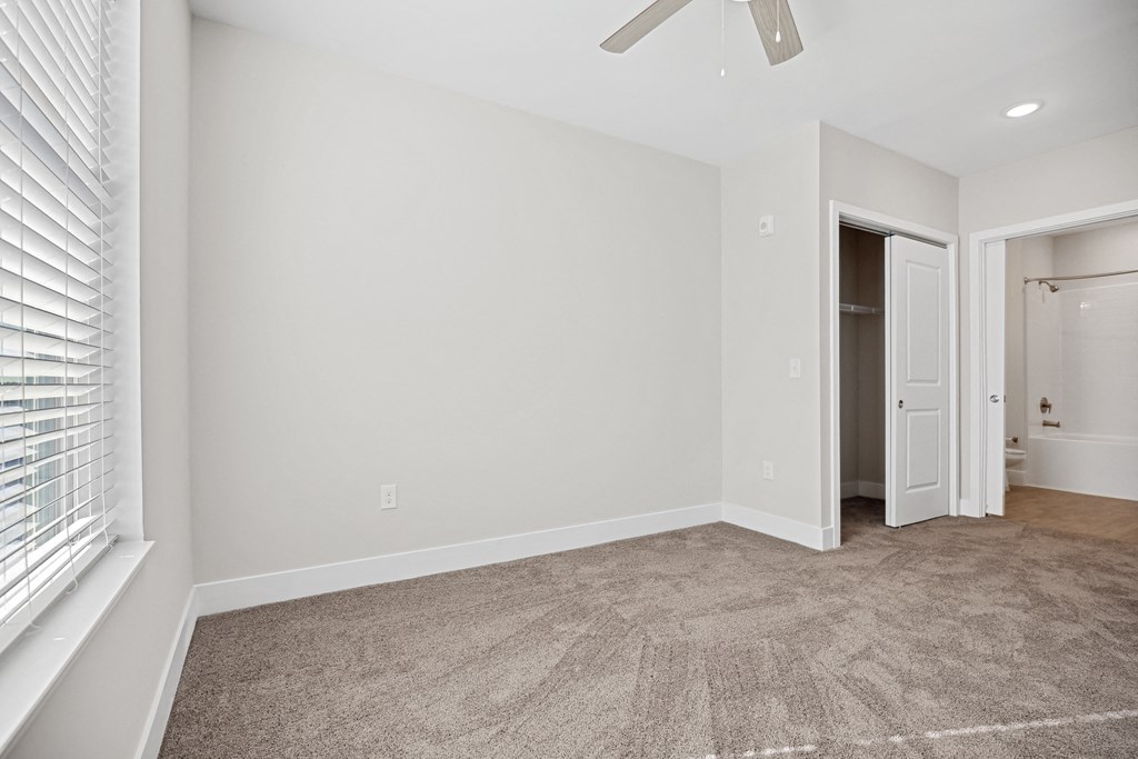 a living room with a carpeted floor and a large windowat Centro at Pine Nash, North Carolina, 27893