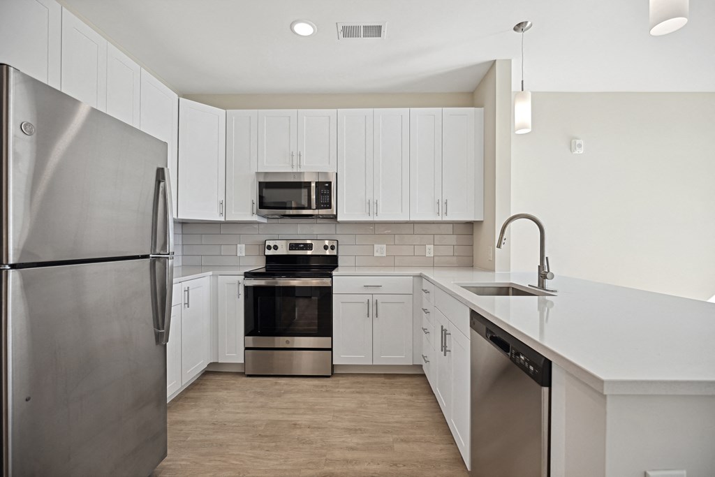 an empty kitchen with white cabinets and stainless steel appliancesat Centro at Pine Nash, Wilson, NC, 27893