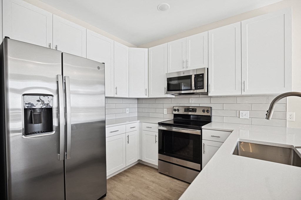 a kitchen with stainless steel appliances and white cabinetsat Centro at Pine Nash, Wilson, NC, 27893