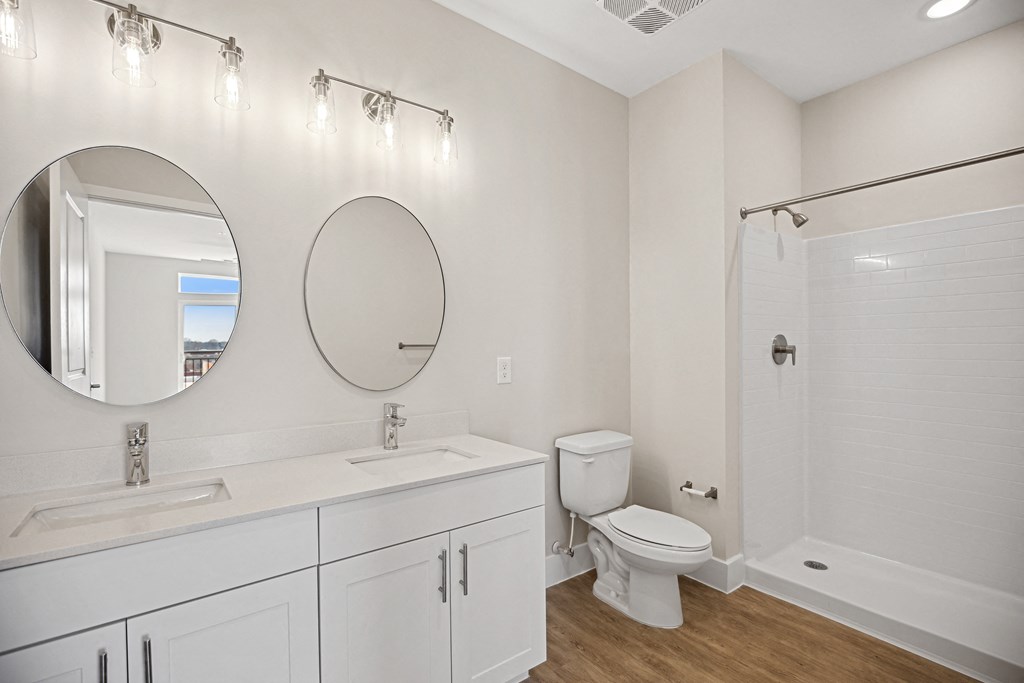a white bathroom with a toilet and a sink and a mirrorat Centro at Pine Nash, North Carolina, 27893