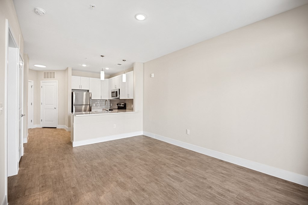 an empty living room and kitchen in a new homeat Centro at Pine Nash, Wilson, NC