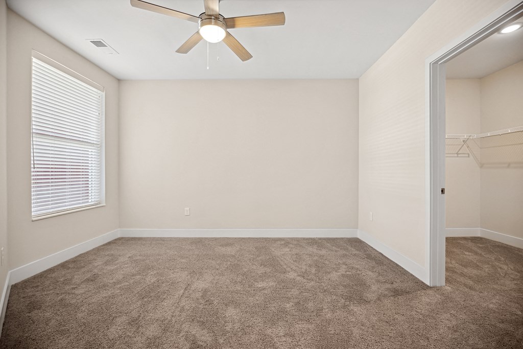 an empty bedroom with a ceiling fan and a closetat Centro at Pine Nash, Wilson, North Carolina