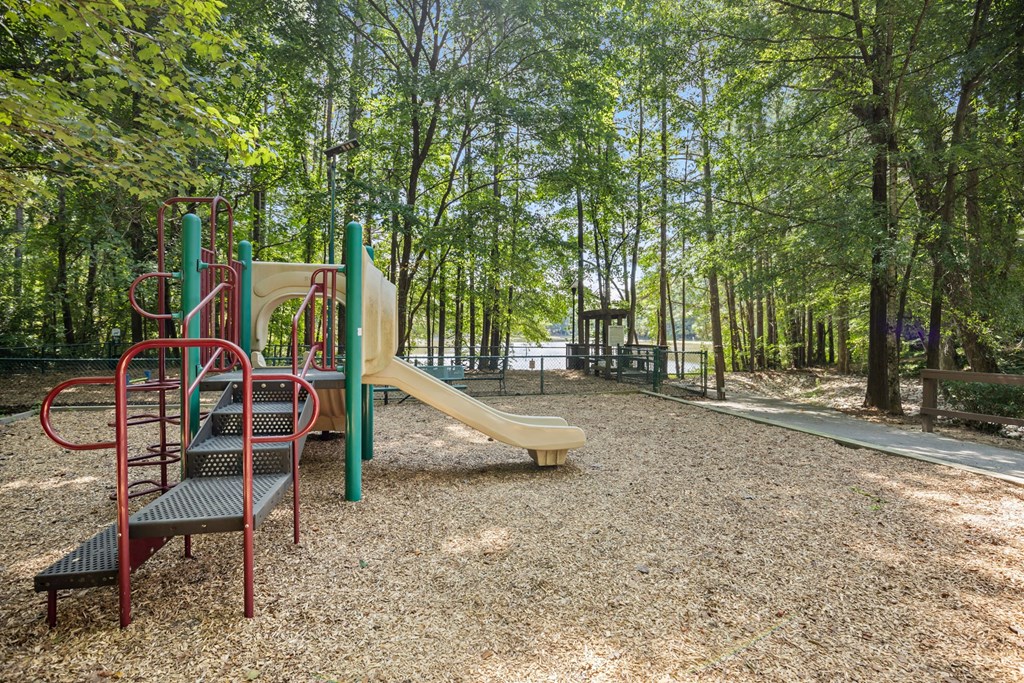 A playground with a slide, swings, and a climbing frame.