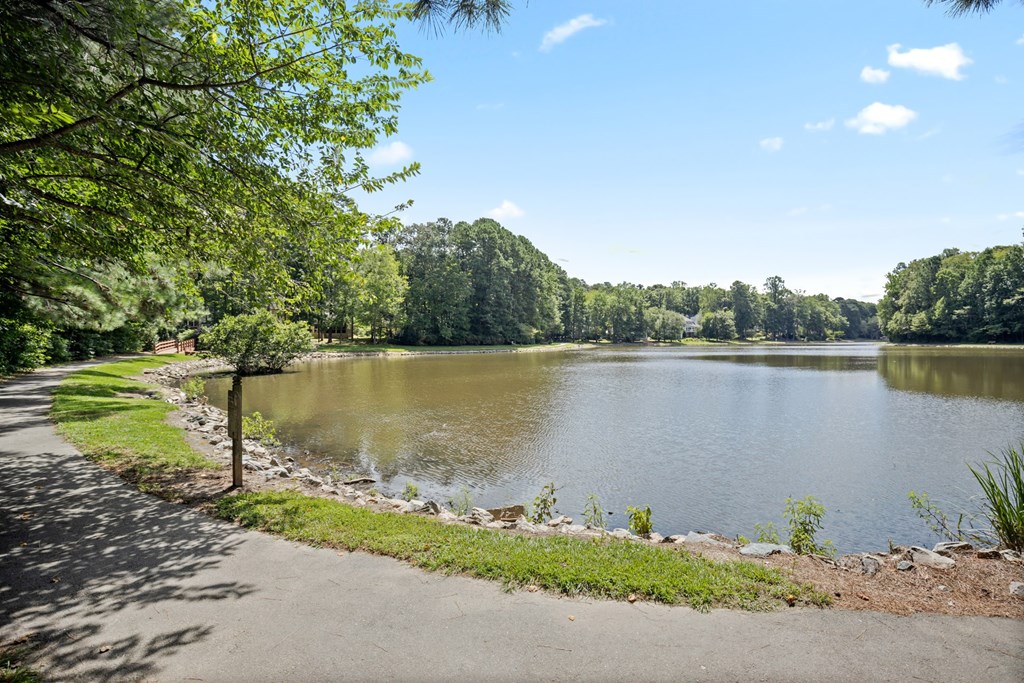 A lake surrounded by trees and a clear sky.
