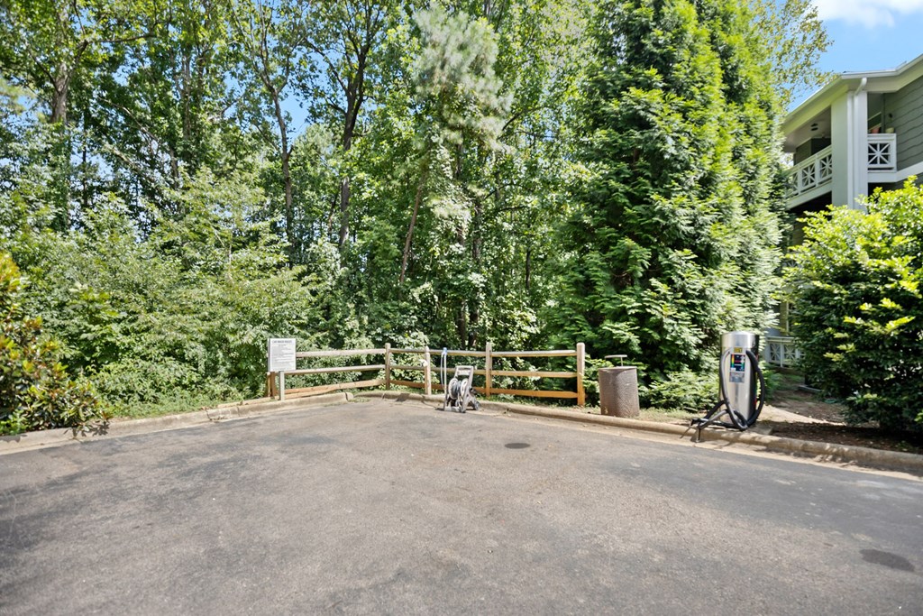 A sign is on a gate in front of a house.