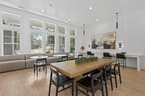 A dining room with a wooden table and chairs.