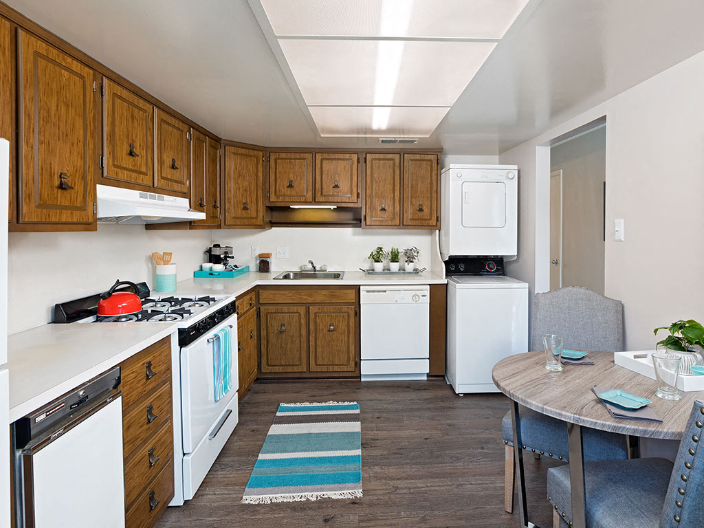 A kitchen with wooden cabinets and white appliances.