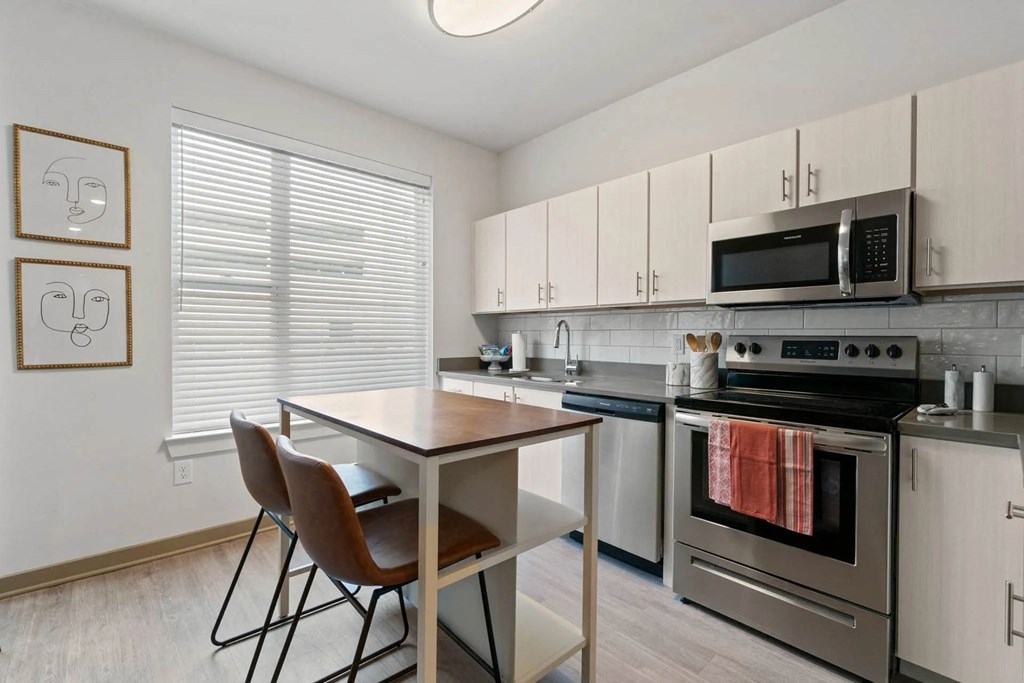 a room with a mirrored wall with different types of chairsat Metropolis Apartments, Virginia, 23060